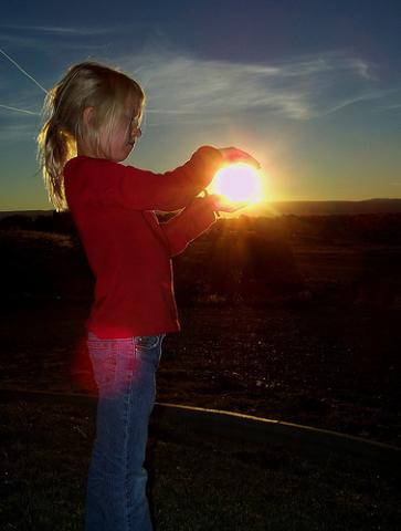 Girl holding the Sun